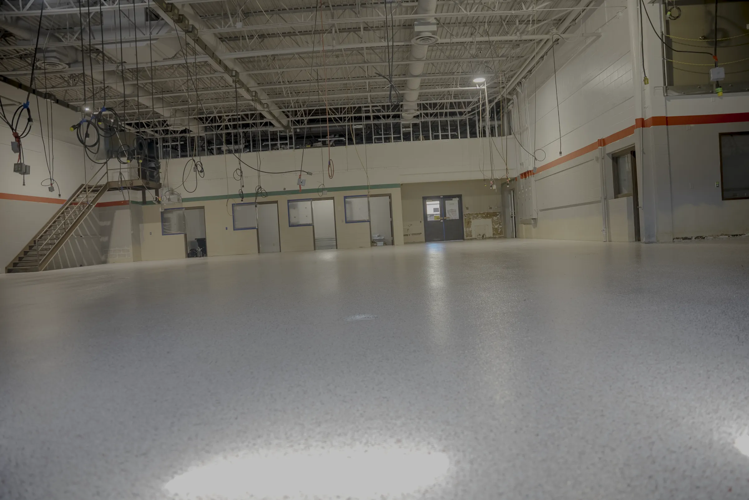 Finished light gray commercial floor across a large open interior